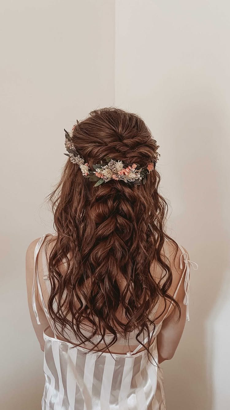 Long wavy brown hair with a fishtail braid and a floral crown
