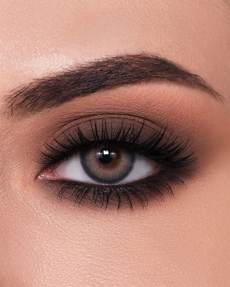 Close-up of an eye with bronze eyeshadow and long dramatic false eyelashes.