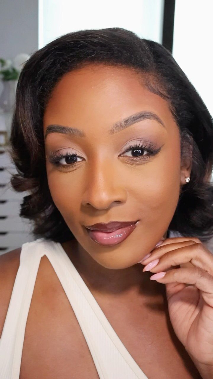 Woman with soft brown eye makeup and neutral lips posing for a portrait