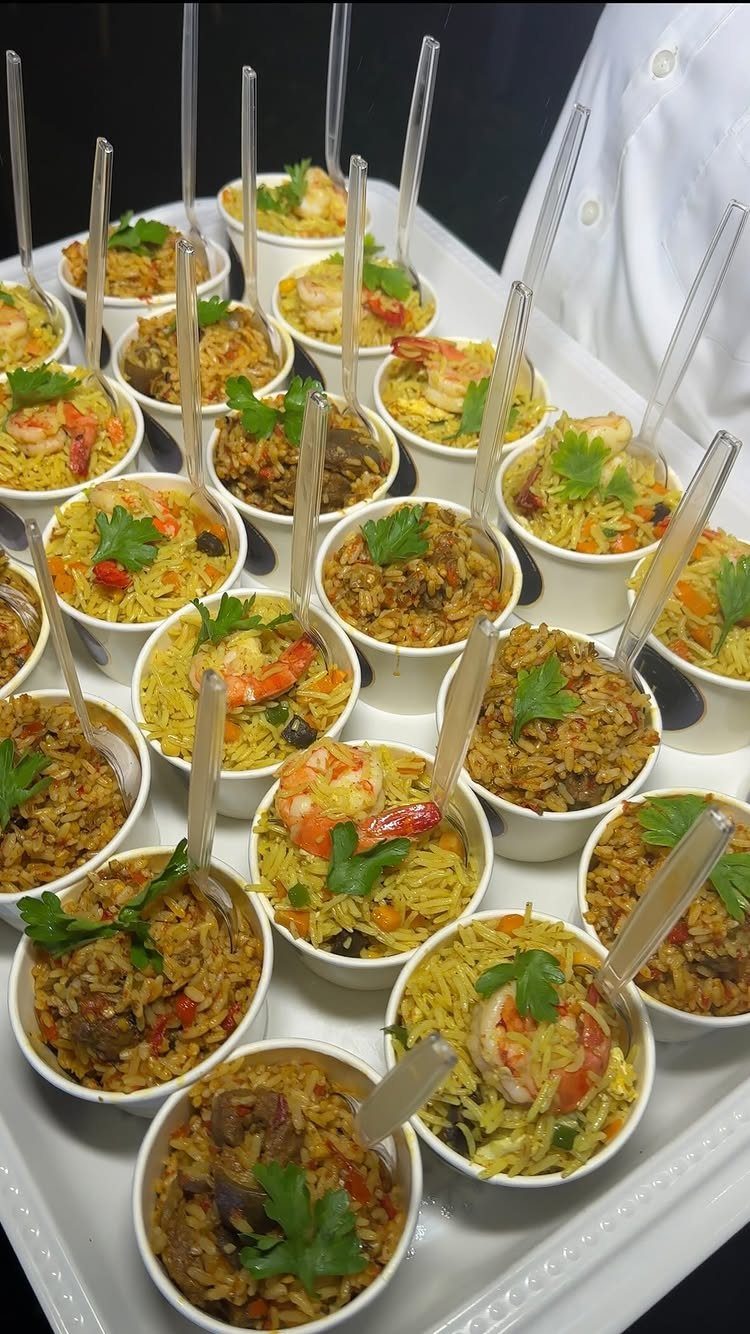 Small white cups of shrimp and vegetable rice appetizers on a white tray