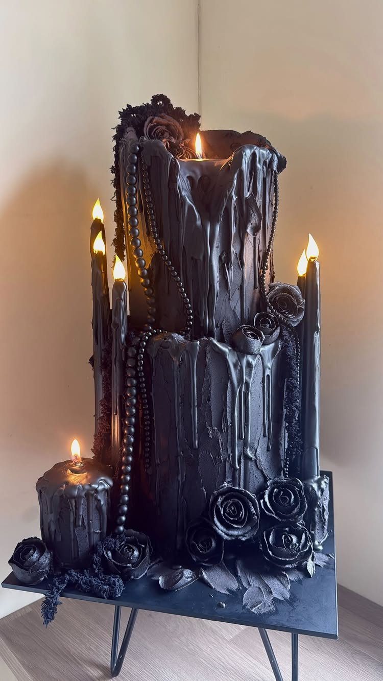 Black gothic wedding cake designed as melting candles with black roses and beads.