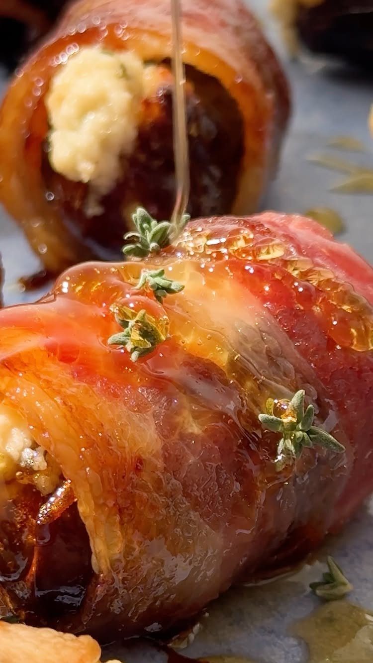 Bacon-wrapped dates stuffed with cheese and drizzled with honey and fresh thyme.