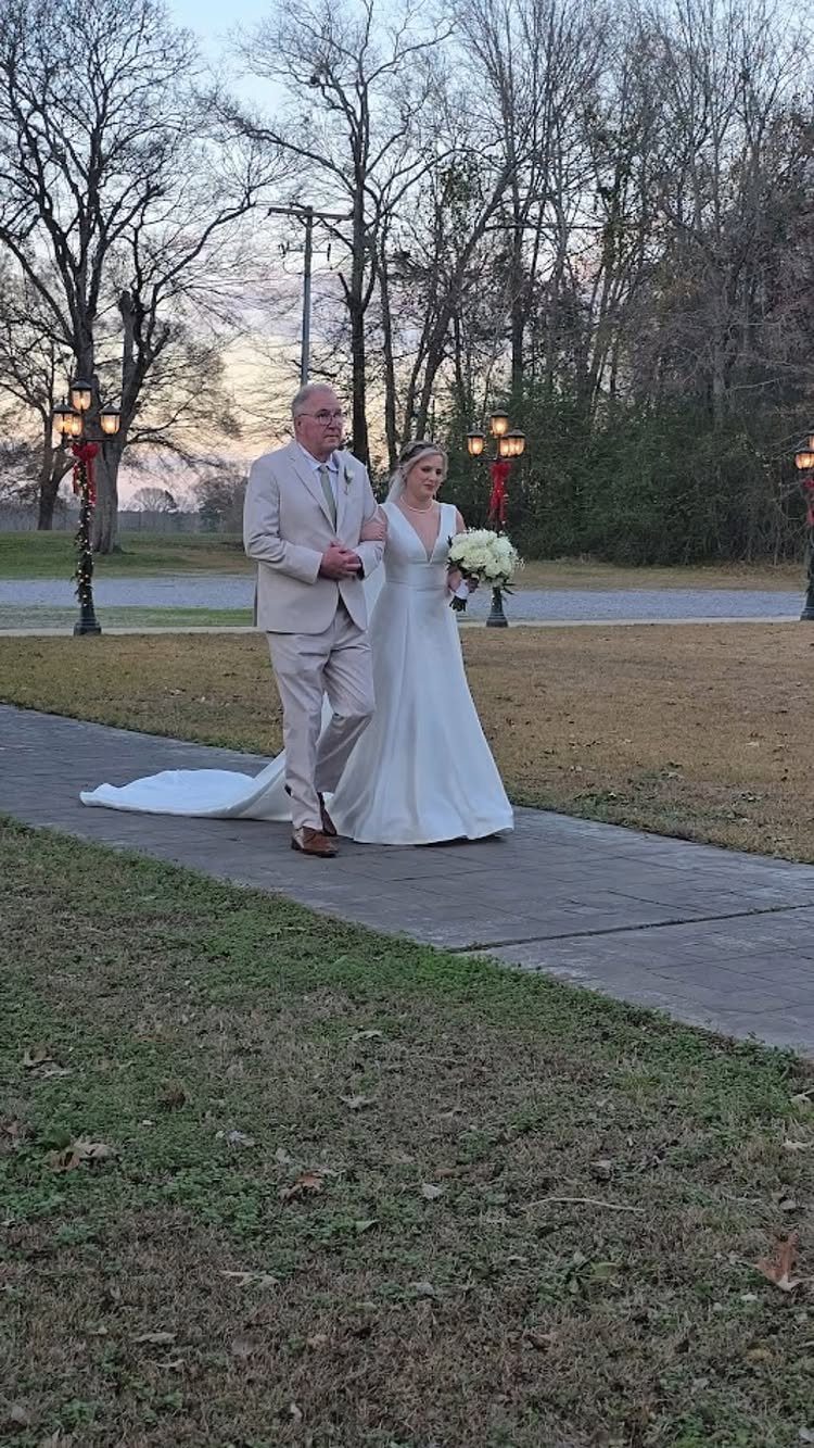 Father walking his daughter down the aisle in a white wedding dress