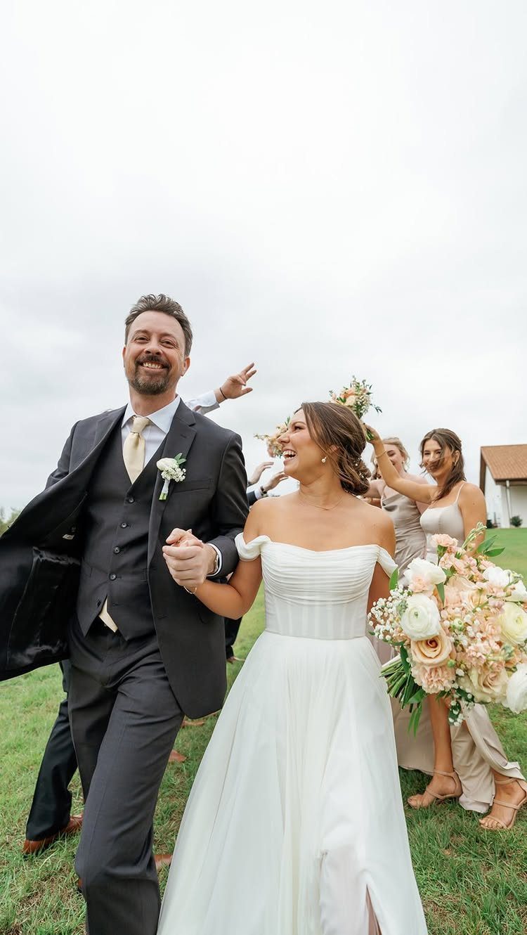 Newlywed couple walking joyfully together outdoors after their wedding ceremony.