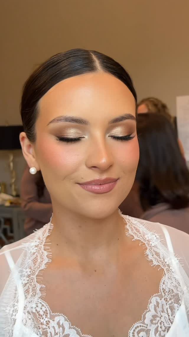 Woman with closed eyes showing gold shimmering bridal eyeshadow and neutral makeup.
