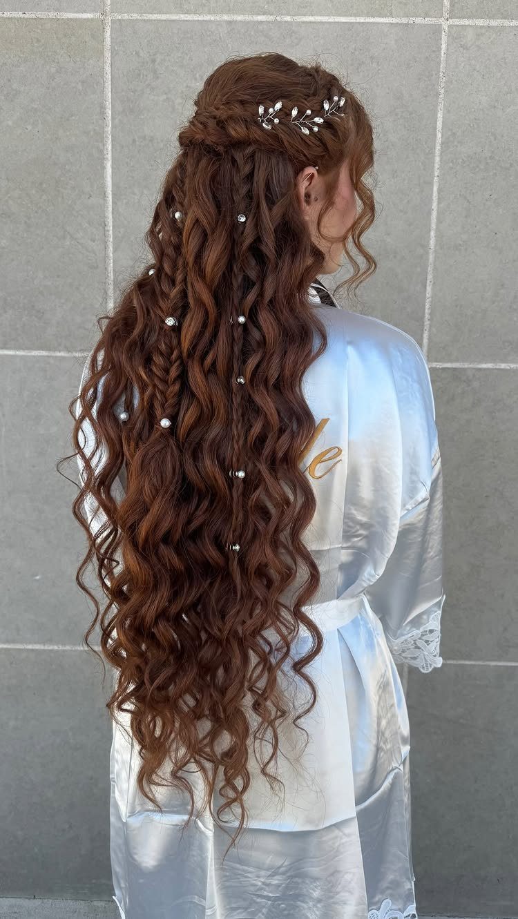 Long curly auburn hair with a pearl-accented braid and silver leaf hairpiece